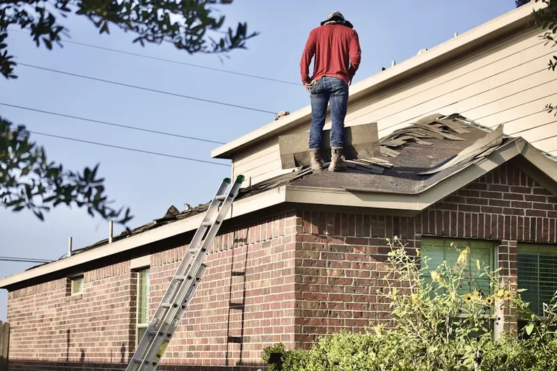 Professional roofer working on a residential roof in Centerburg